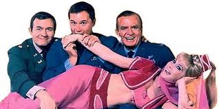 Genie in the 60s in the hit show I Dream of Jeannie. Biting her hand is co-star Larry Hagman.
